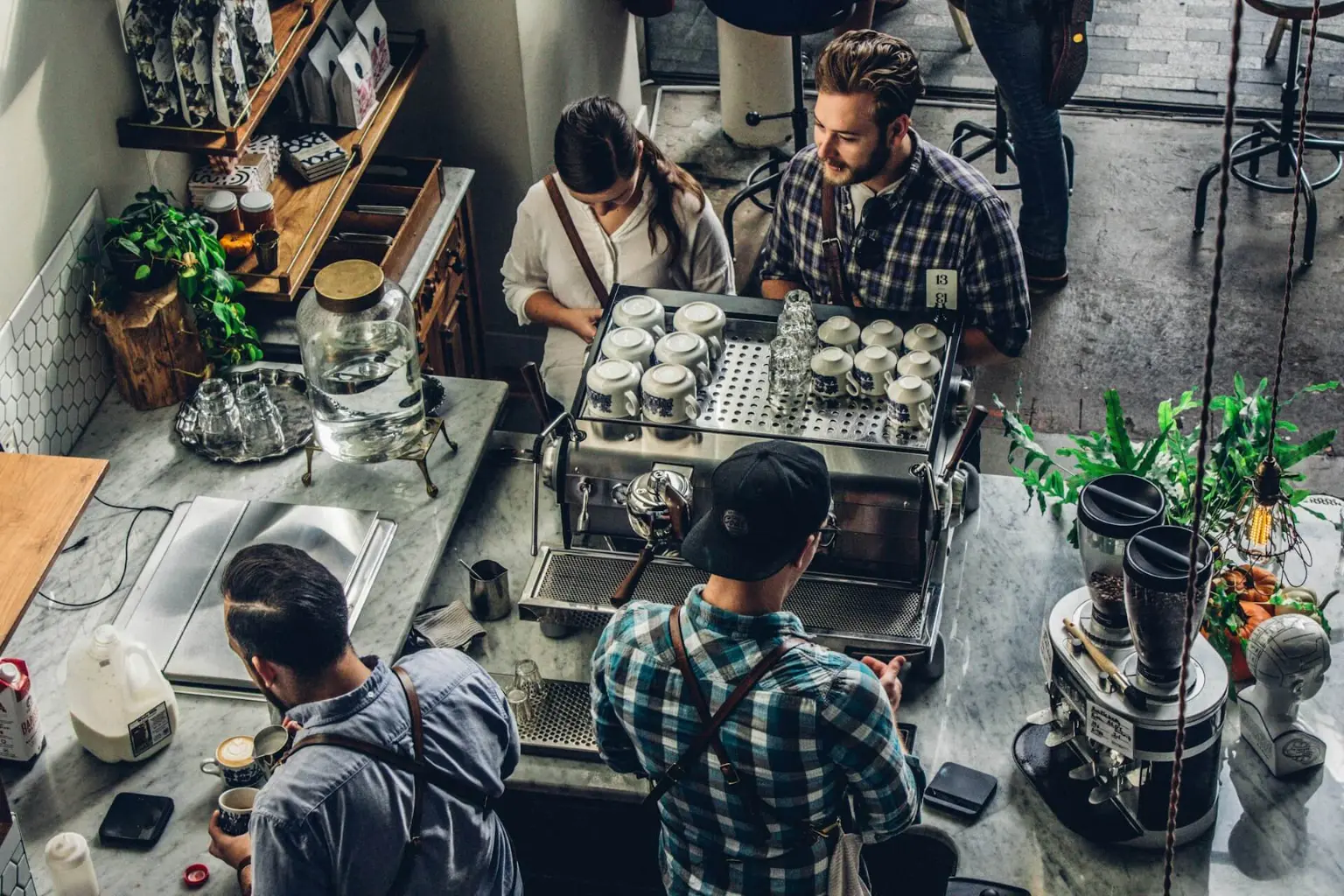 Baristas working behind a busy cafe counter