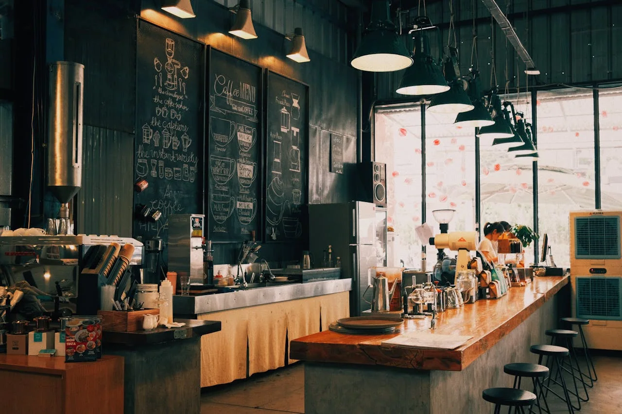 Interior of a cafe with a long service counter and menu boards