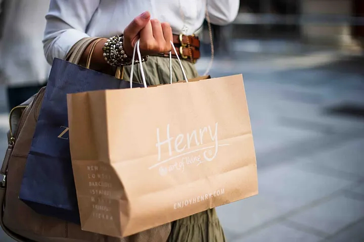 Shopper carrying paper shopping bags