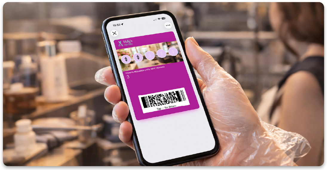 Client holding a digital salon loyalty card on a smartphone